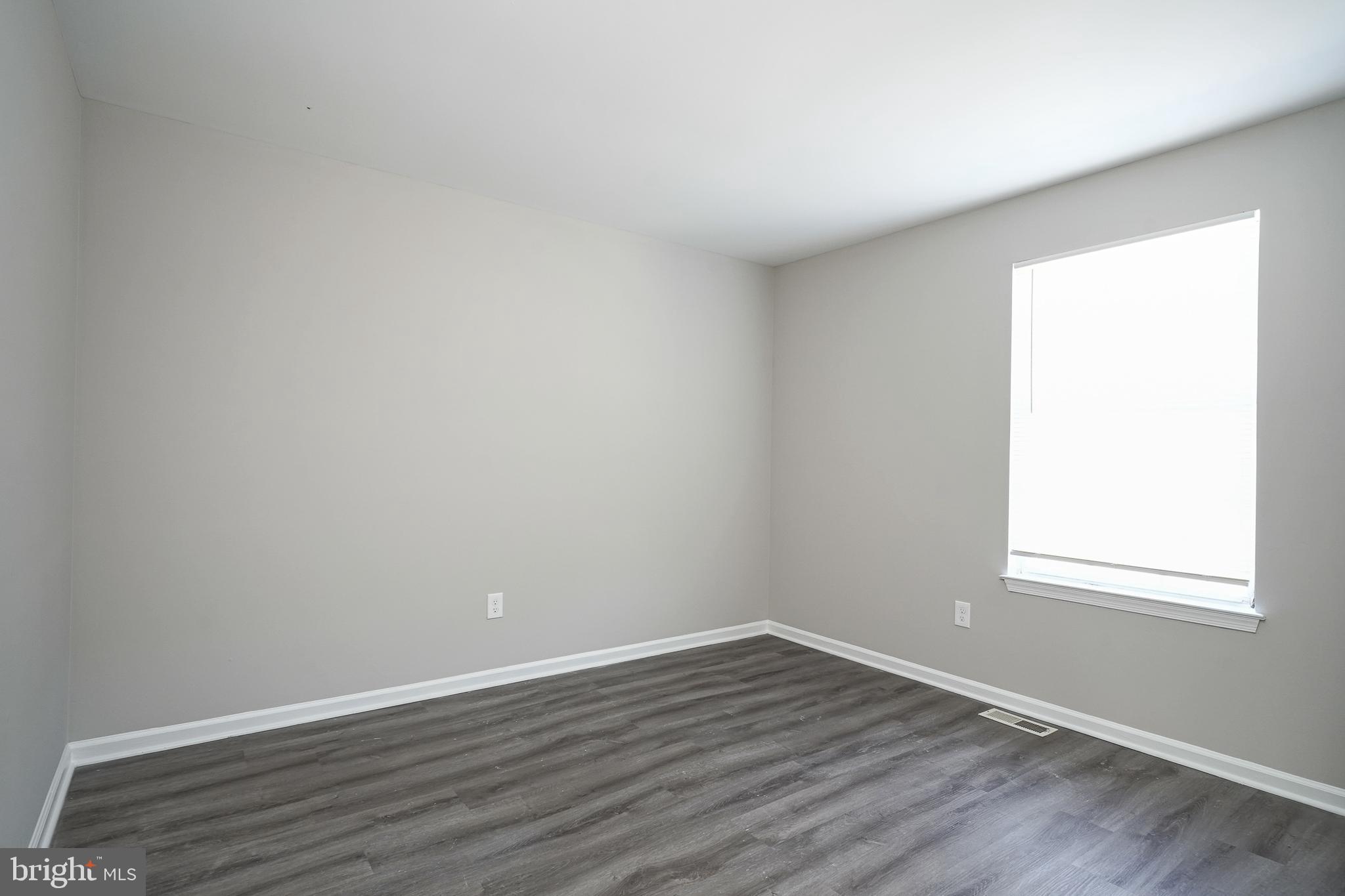 3002 Tall Pines Pine Hill, NJ 08021 - Photo 9 of 29 a view of an empty room with wooden floor and a window