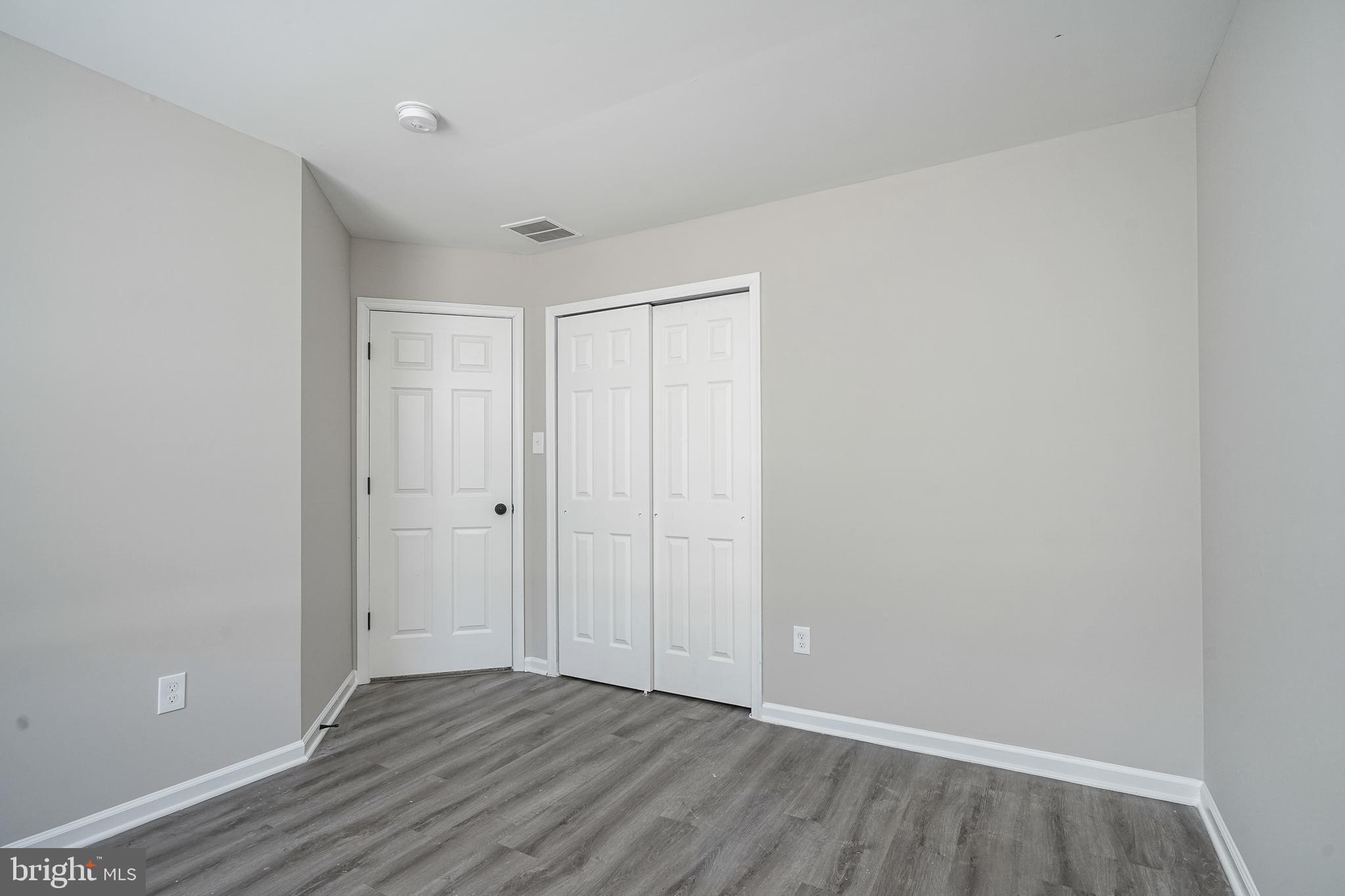 3002 Tall Pines Pine Hill, NJ 08021 - Photo 10 of 29 a view of an empty room with wooden floor and a window