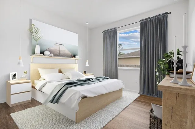 a bedroom with a bed and a potted plant