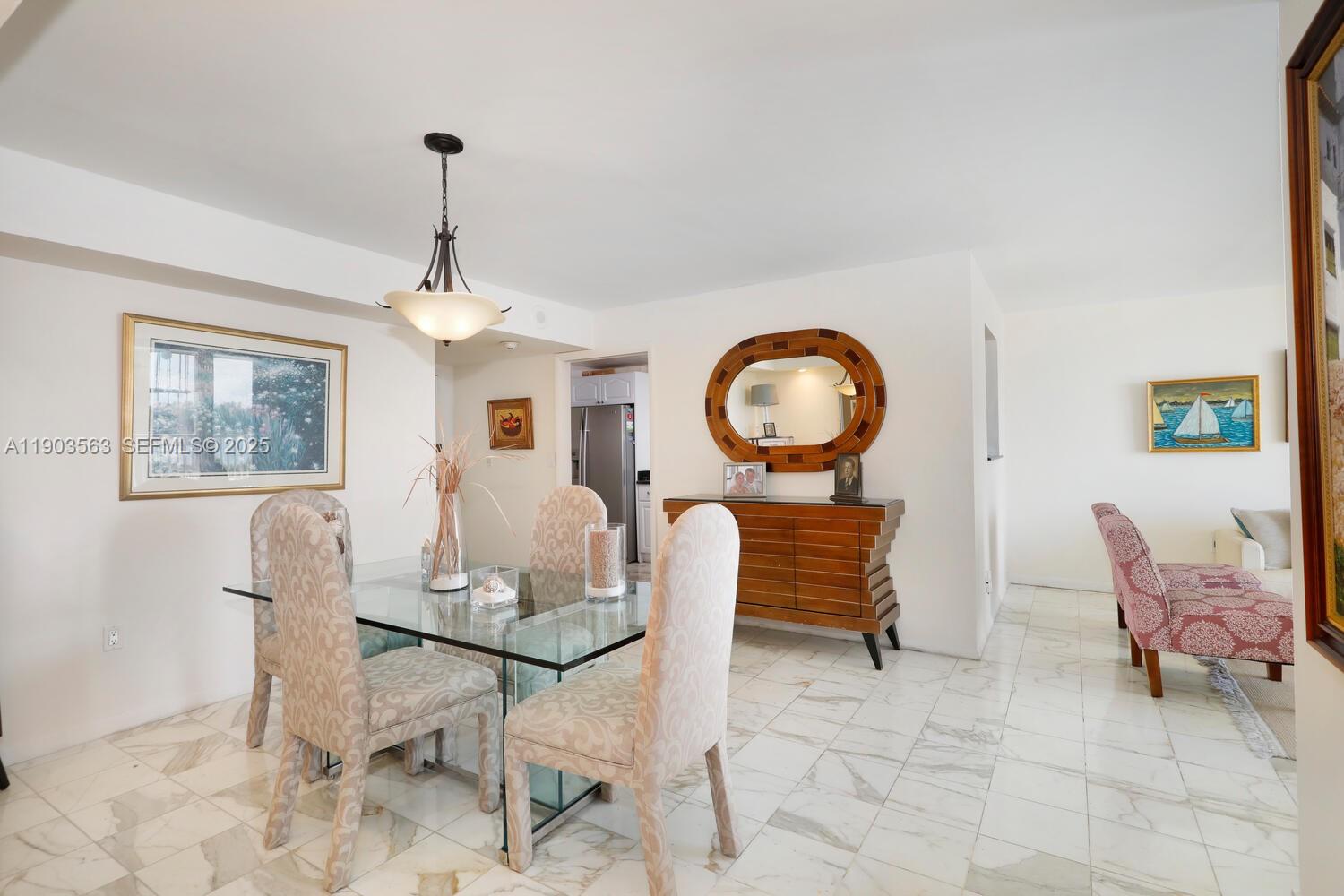 145 Southeast 25th Road, Unit 702 Miami, FL 33129 - Photo 14 of 27 a dining room with furniture and a chandelier
