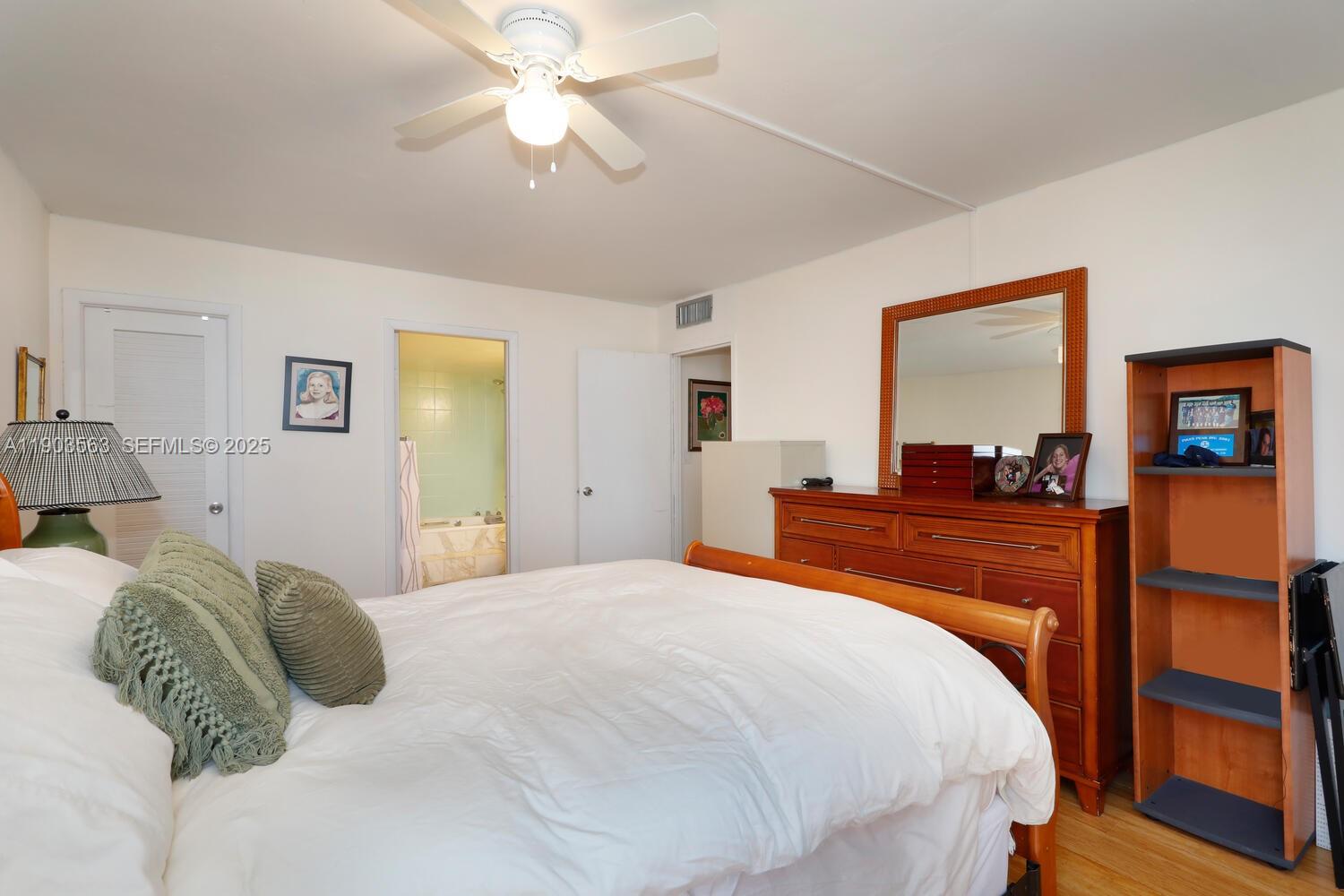 145 Southeast 25th Road, Unit 702 Miami, FL 33129 - Photo 20 of 27 a bedroom with a bed and a mirror on the dresser