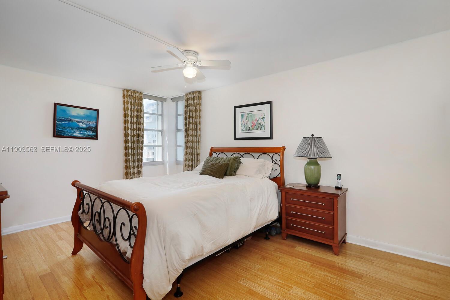 145 Southeast 25th Road, Unit 702 Miami, FL 33129 - Photo 6 of 27 a bedroom with a bed and a night stand