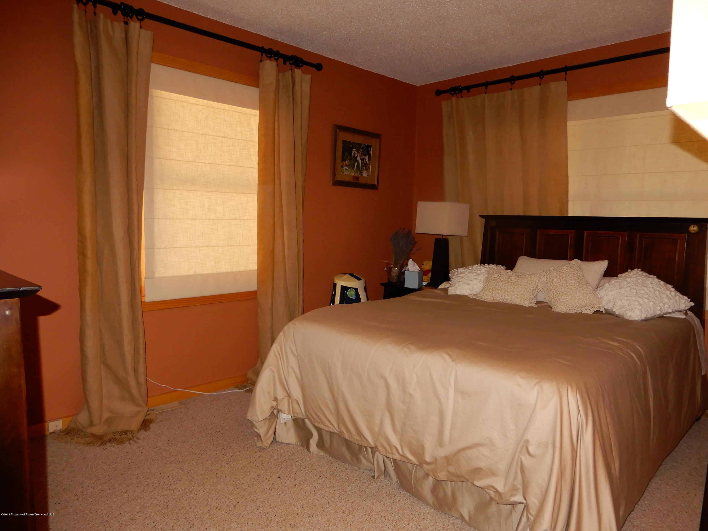 560 Will Avenue Rifle, CO 81650 - Photo 15 of 18 a bedroom with a bed and a window