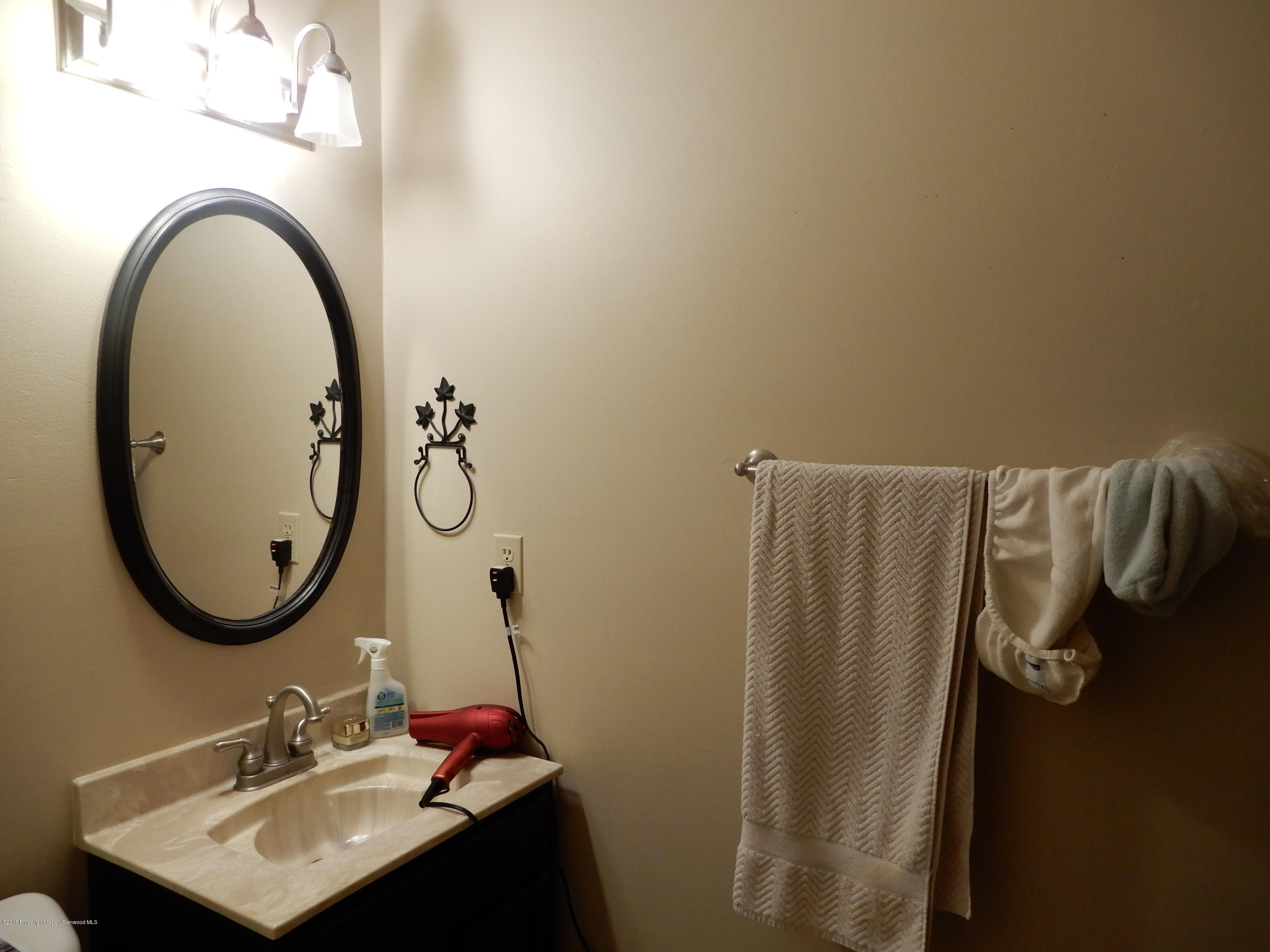 560 Will Avenue Rifle, CO 81650 - Photo 16 of 18 a bathroom with a sink and a mirror
