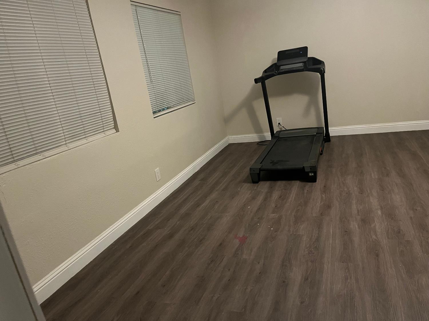 800 Wessmith Way Madera, CA 93638 - Photo 13 of 24 a room with wooden floor and mirror