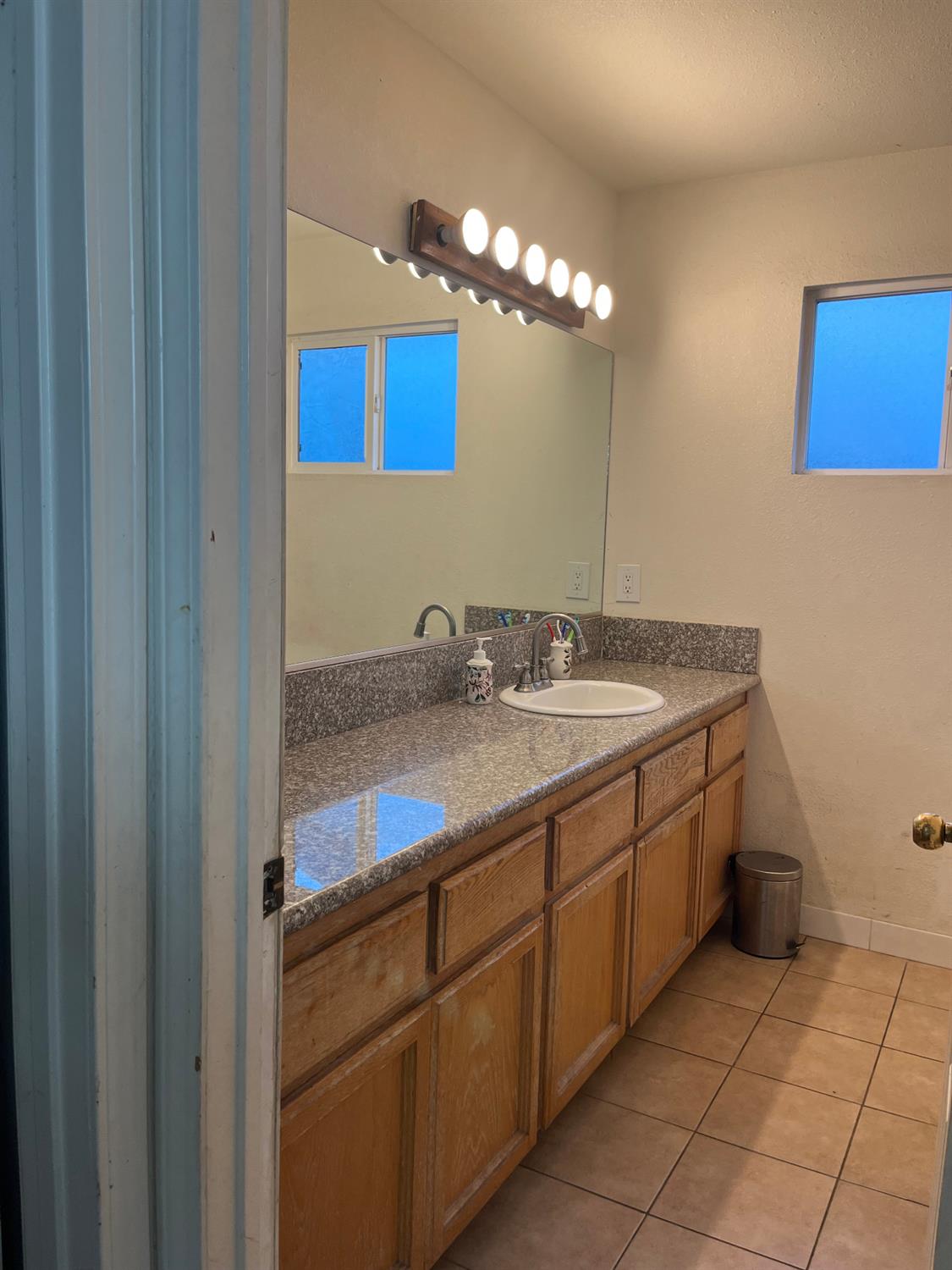 800 Wessmith Way Madera, CA 93638 - Photo 15 of 24 a bathroom with a sink a vanity and a mirror
