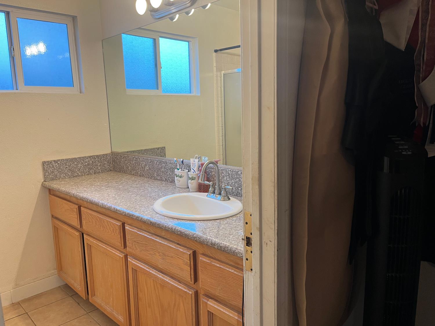 800 Wessmith Way Madera, CA 93638 - Photo 18 of 24 a bathroom with a sink and a mirror
