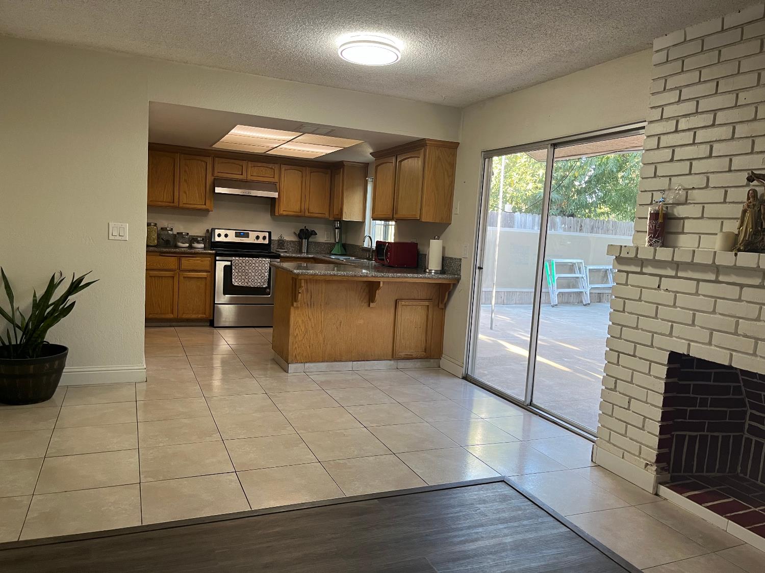 800 Wessmith Way Madera, CA 93638 - Photo 6 of 24 a kitchen with stainless steel appliances granite countertop a refrigerator a sink a stove top oven a counter space and cabinets