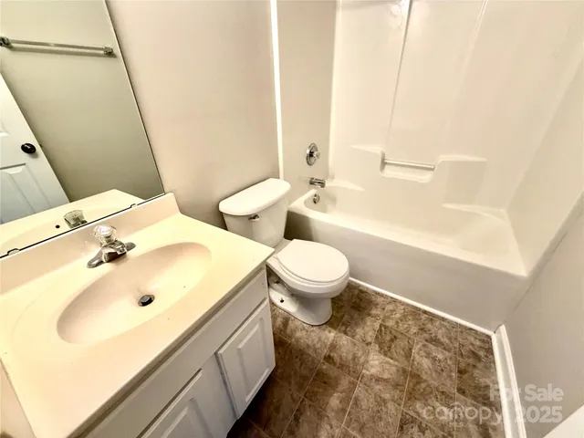 a view of empty room with stairs and a window