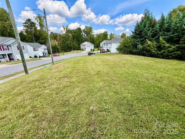 a view of a house with a yard and garage