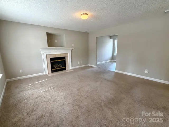a view of empty room with a fireplace