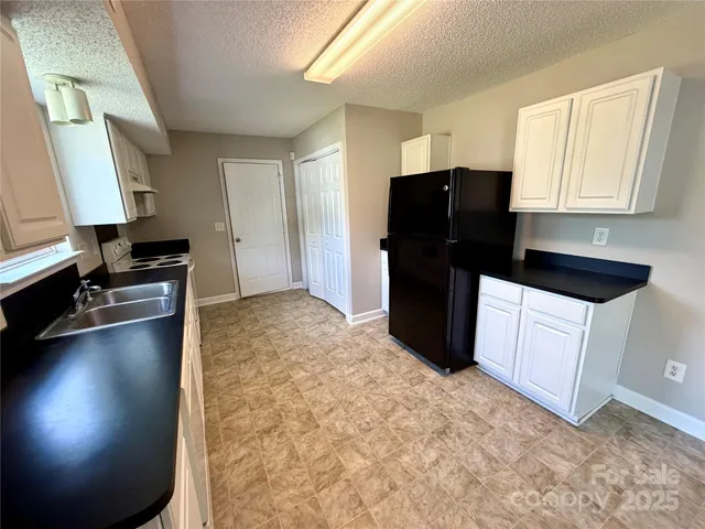 a kitchen with a refrigerator and a stove