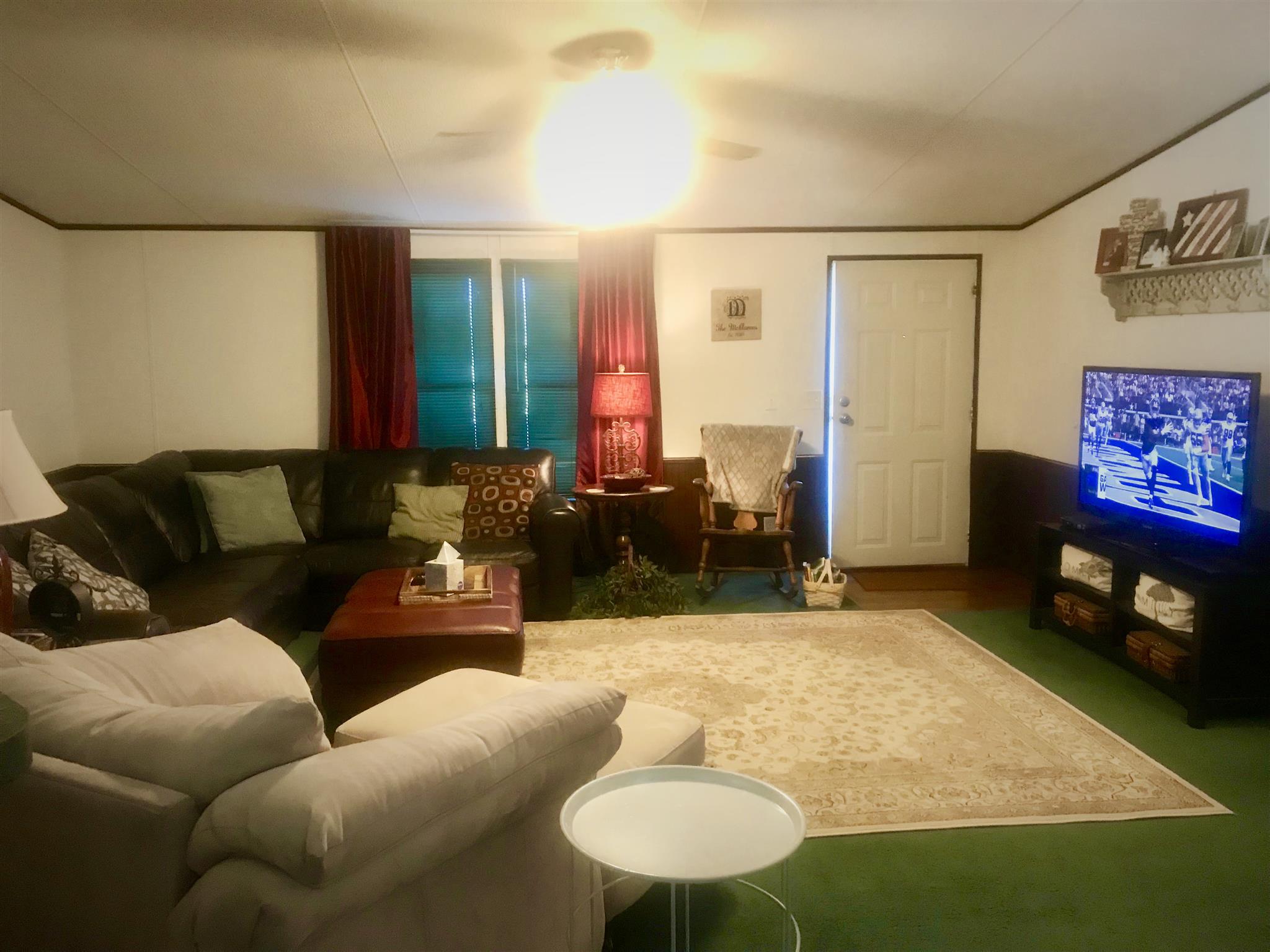 7596 Franklin Road Mount Juliet, TN 37122 - Photo 2 of 16 a living room with furniture and a flat screen tv