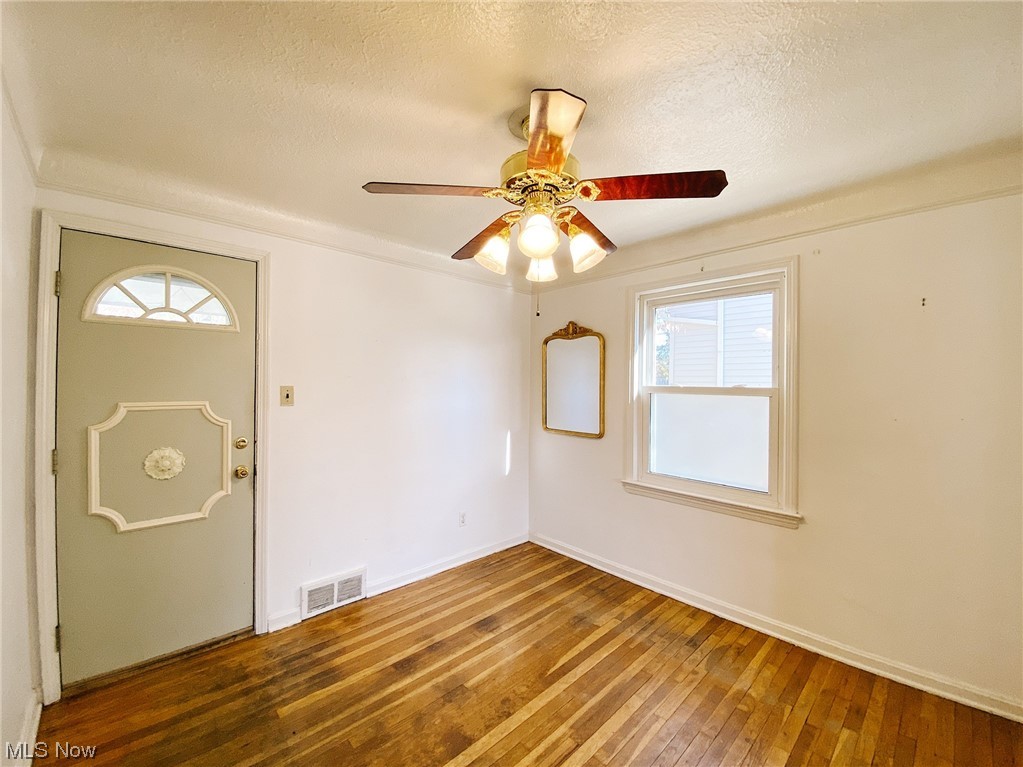 9704 Snow Road Cleveland, OH 44130 - Photo 8 of 24 Dining room with ceiling fan, a textured ceiling, plenty of natural light, and hardwood / wood-style floors