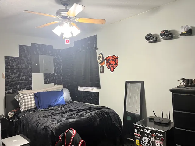 a bedroom with a bed and a chandelier