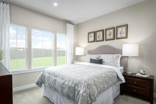 a bedroom with a bed and a night stand