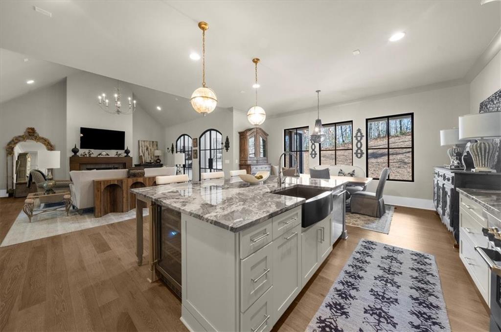 9773 Hightower Road Roswell, GA 30075 - Photo 15 of 79 a large kitchen with kitchen island a sink counter space and living room view
