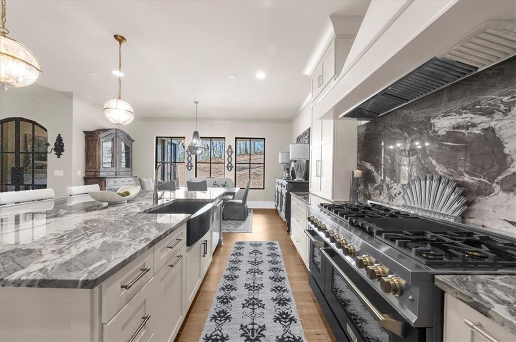 9773 Hightower Road Roswell, GA 30075 - Photo 20 of 79 a large kitchen with a stove and a wooden floor