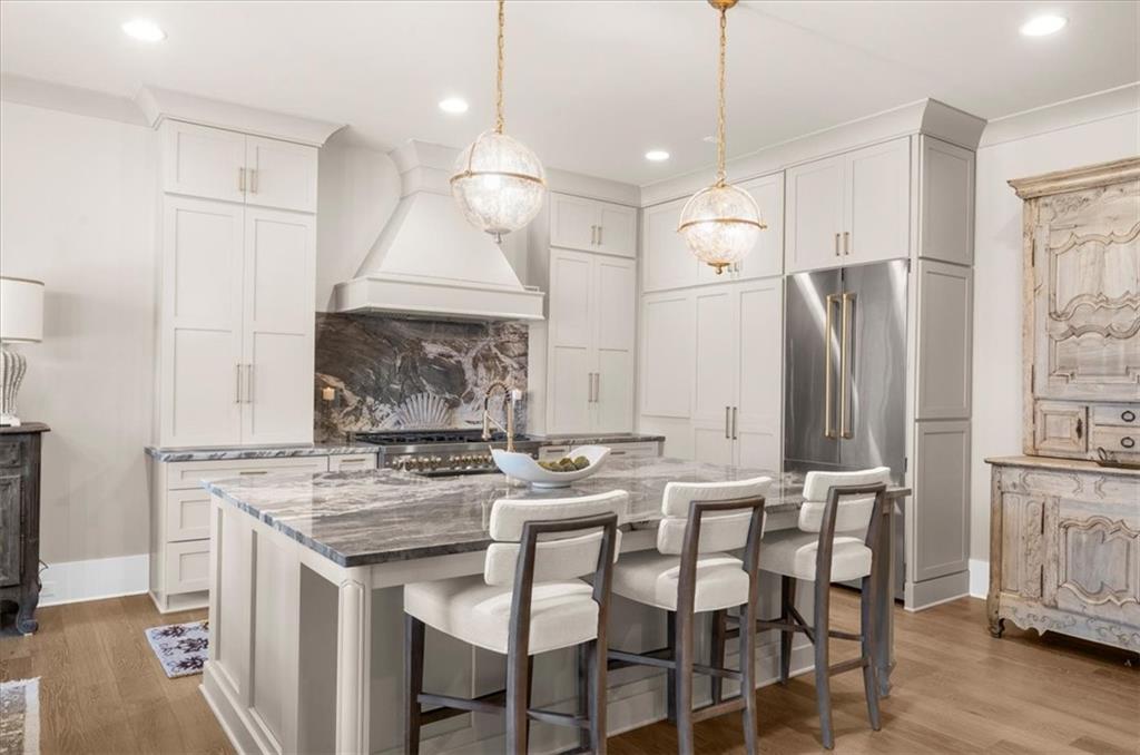 9773 Hightower Road Roswell, GA 30075 - Photo 24 of 79 a kitchen with stainless steel appliances granite countertop a stove a refrigerator and a wooden floor