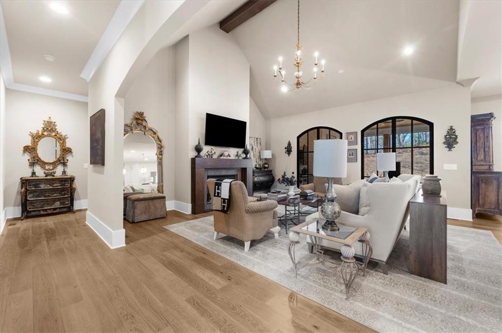 9773 Hightower Road Roswell, GA 30075 - Photo 26 of 79 a living room with furniture a fireplace and a flat screen tv