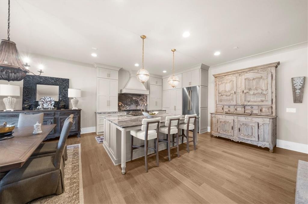 9773 Hightower Road Roswell, GA 30075 - Photo 28 of 79 a kitchen with stainless steel appliances kitchen island granite countertop a stove a sink a refrigerator and cabinets