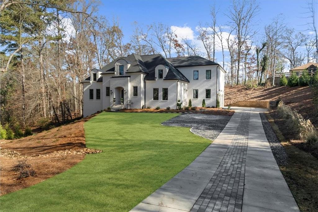 9773 Hightower Road Roswell, GA 30075 - Photo 3 of 79 a front view of a house with garden