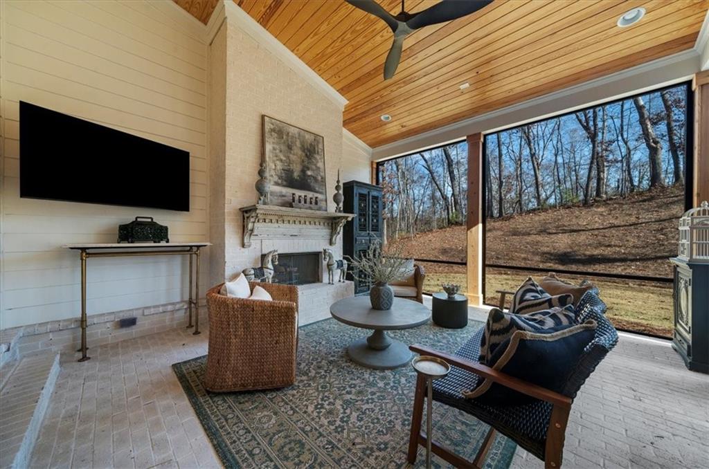 9773 Hightower Road Roswell, GA 30075 - Photo 45 of 79 a living room with fireplace furniture and a flat screen tv