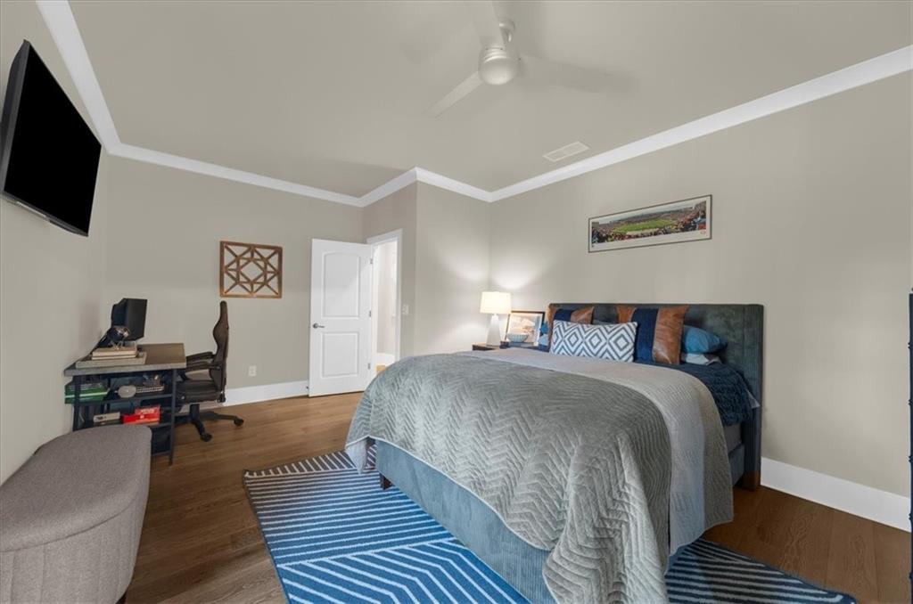 9773 Hightower Road Roswell, GA 30075 - Photo 55 of 79 a bedroom with a bed and a flat screen tv
