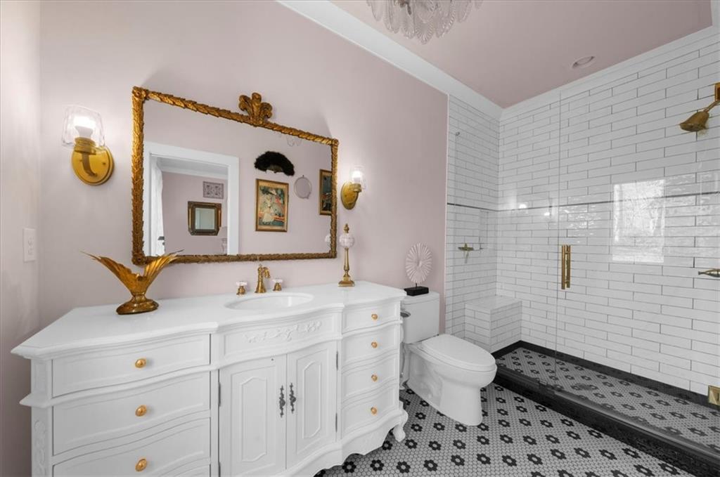 9773 Hightower Road Roswell, GA 30075 - Photo 60 of 79 a bathroom with a sink a toilet and mirror