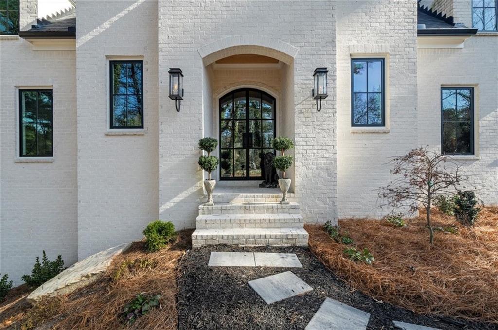 9773 Hightower Road Roswell, GA 30075 - Photo 7 of 79 a front view of a house with a garden