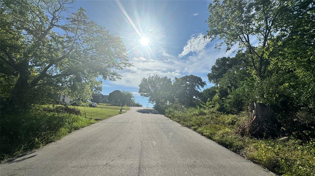 0 East Nelson Street Denison, TX 75021 - Photo 17 of 28 a view of a road with a yard