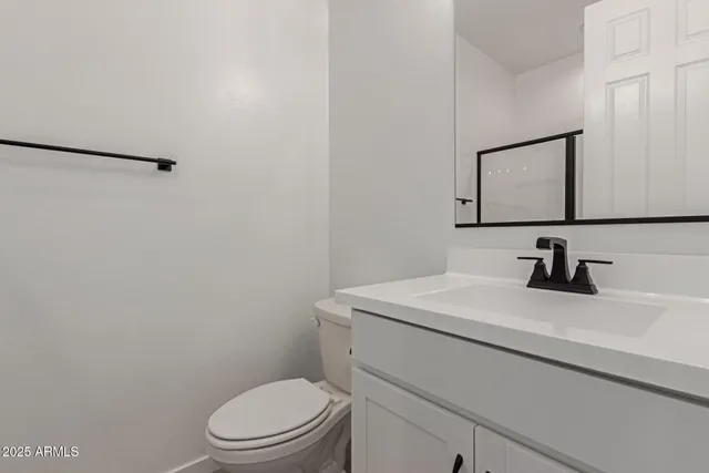 a bathroom with a sink a toilet and mirror
