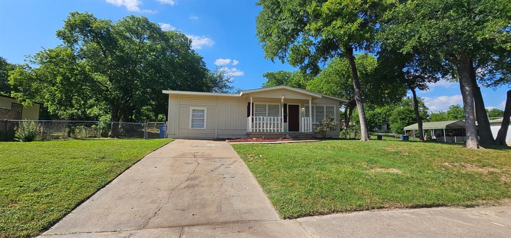 View of front of home featuring a porch and concrete driveway