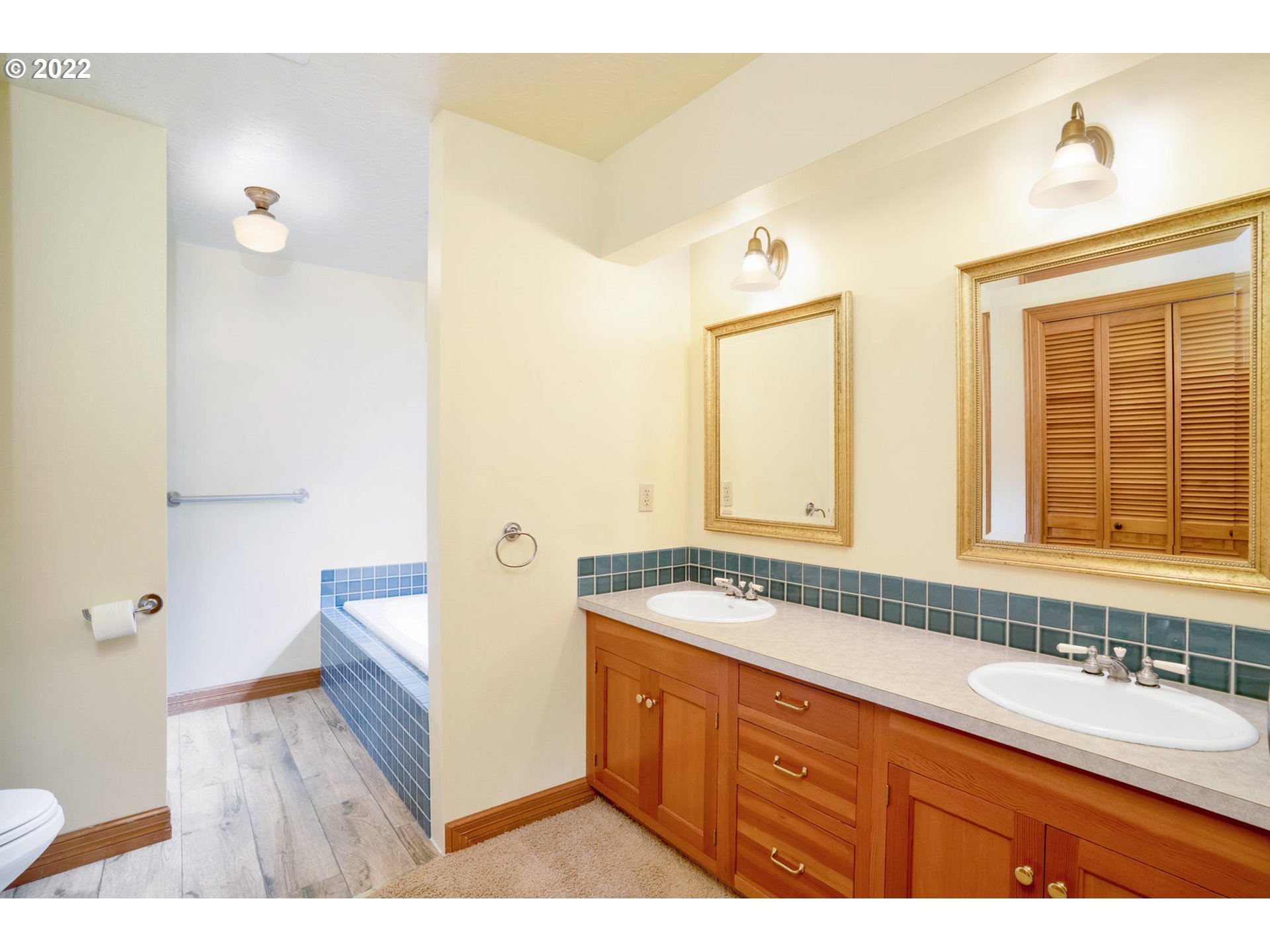 16410 Southeast Royer Road Damascus, OR 97089 - Photo 17 of 32 a spacious bathroom with a granite countertop tub sink and mirror