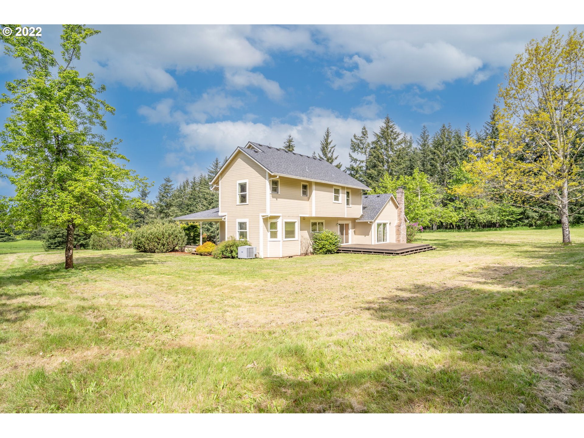 16410 Southeast Royer Road Damascus, OR 97089 - Photo 22 of 32 a white house with a big yard and large trees with wooden fence