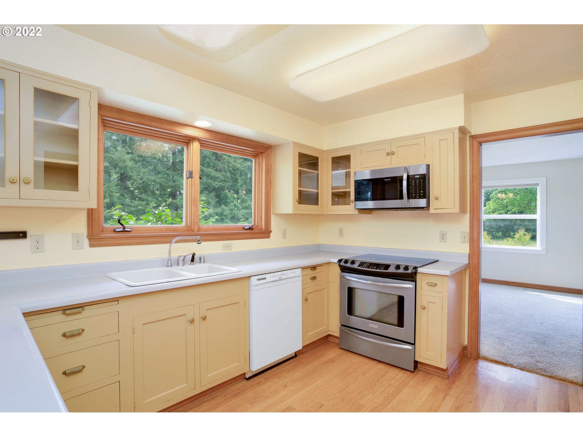 16410 Southeast Royer Road Damascus, OR 97089 - Photo 5 of 32 a kitchen with stainless steel appliances granite countertop a stove a sink and a microwave