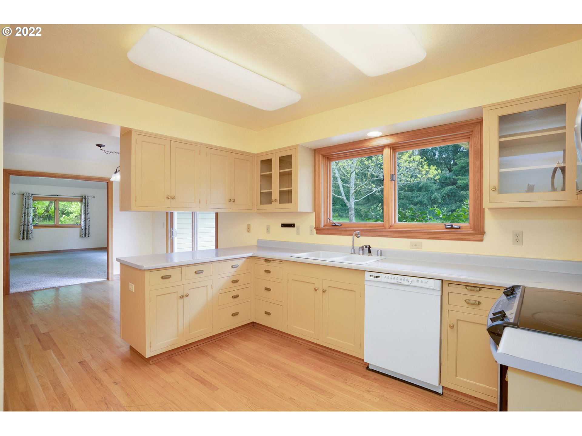 16410 Southeast Royer Road Damascus, OR 97089 - Photo 6 of 32 a kitchen with stainless steel appliances granite countertop a sink and cabinets with wooden floor