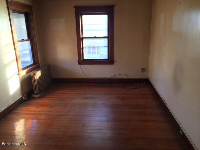156 Elizabeth Street Pittsfield, MA 01201 - Photo 6 of 9 an empty room with wooden floor and windows
