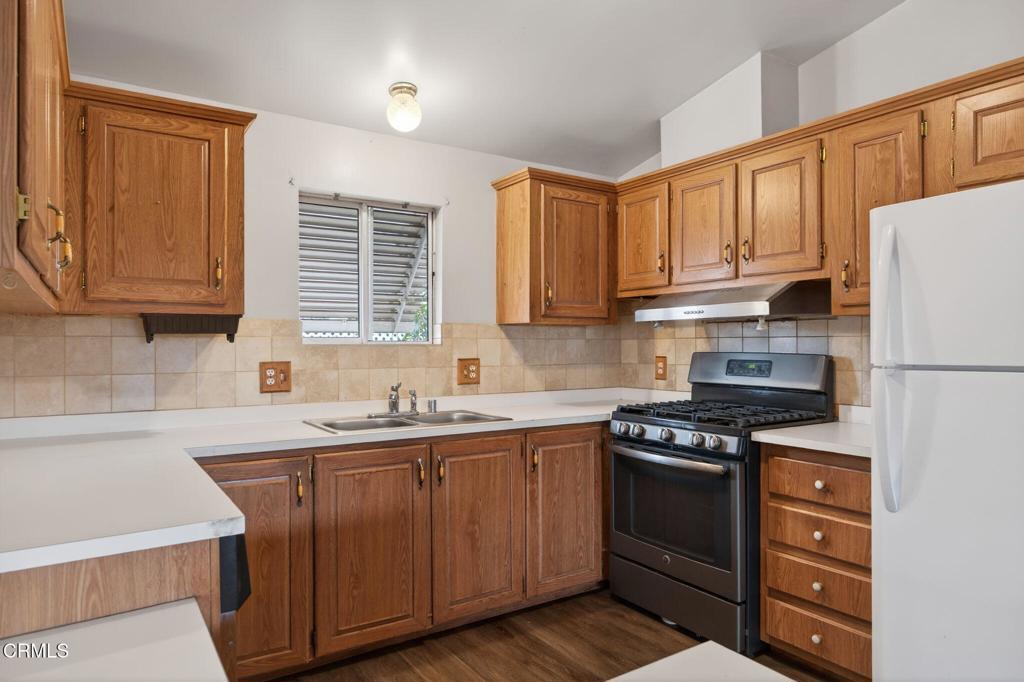 2177 Robin Avenue, Unit 2177A Oxnard, CA 93033 - Photo 14 of 29 a kitchen with stainless steel appliances granite countertop a sink stove and refrigerator