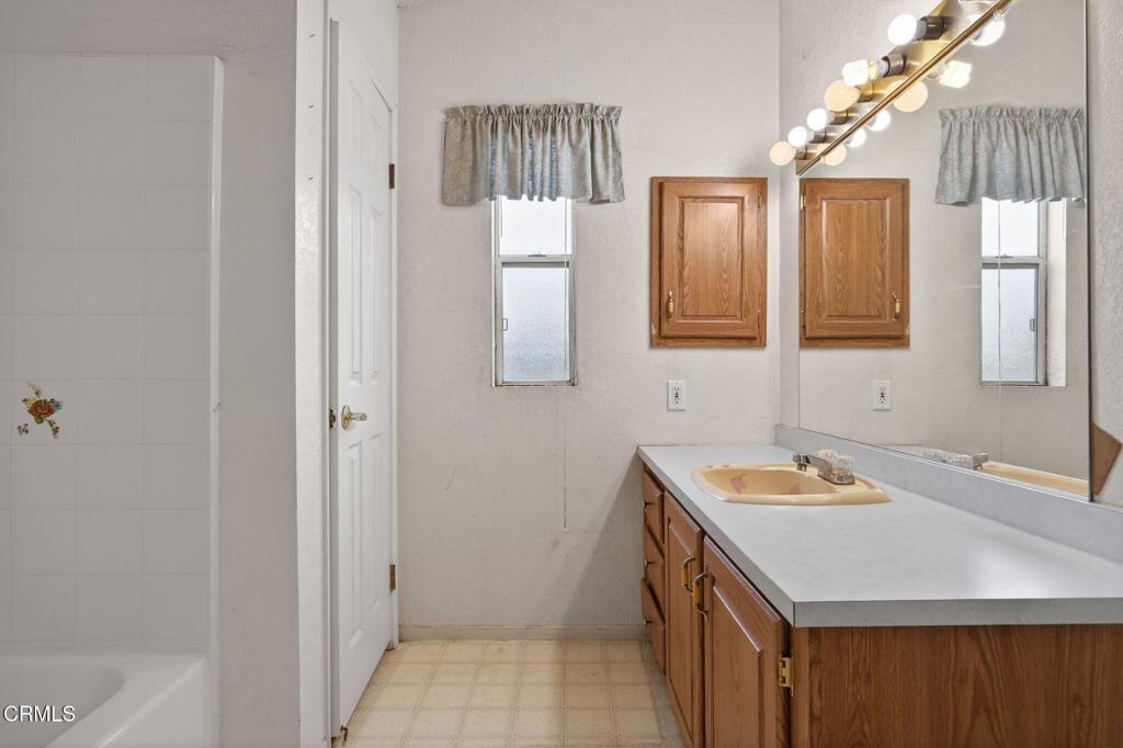 2177 Robin Avenue, Unit 2177A Oxnard, CA 93033 - Photo 23 of 29 a bathroom with a sink a vanity and a mirror