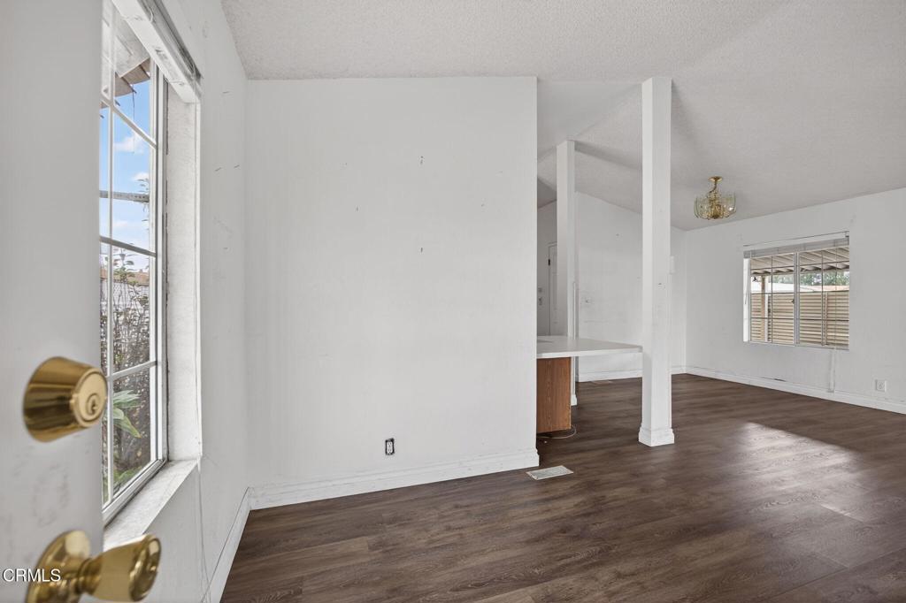 2177 Robin Avenue, Unit 2177A Oxnard, CA 93033 - Photo 6 of 29 an empty room with wooden floor and windows