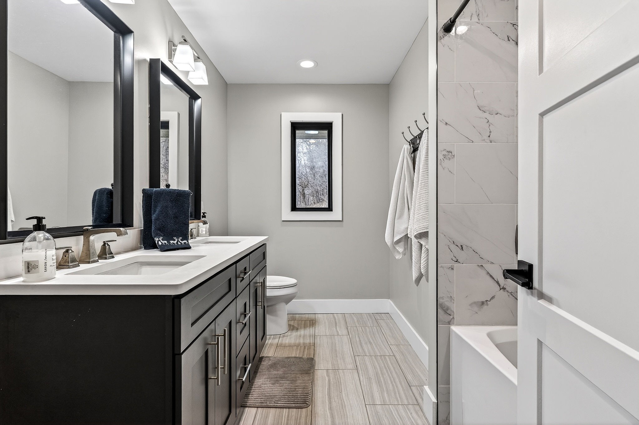 99 Judkins Road Hickman, TN 38567 - Photo 13 of 62 a en suite bathroom with a double vanity sink a mirror and a shower