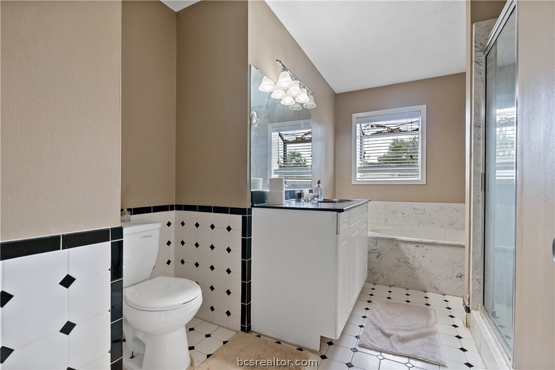 8166 Riley Road Bryan, TX 77808 - Photo 32 of 46 a bathroom with a sink toilet and window