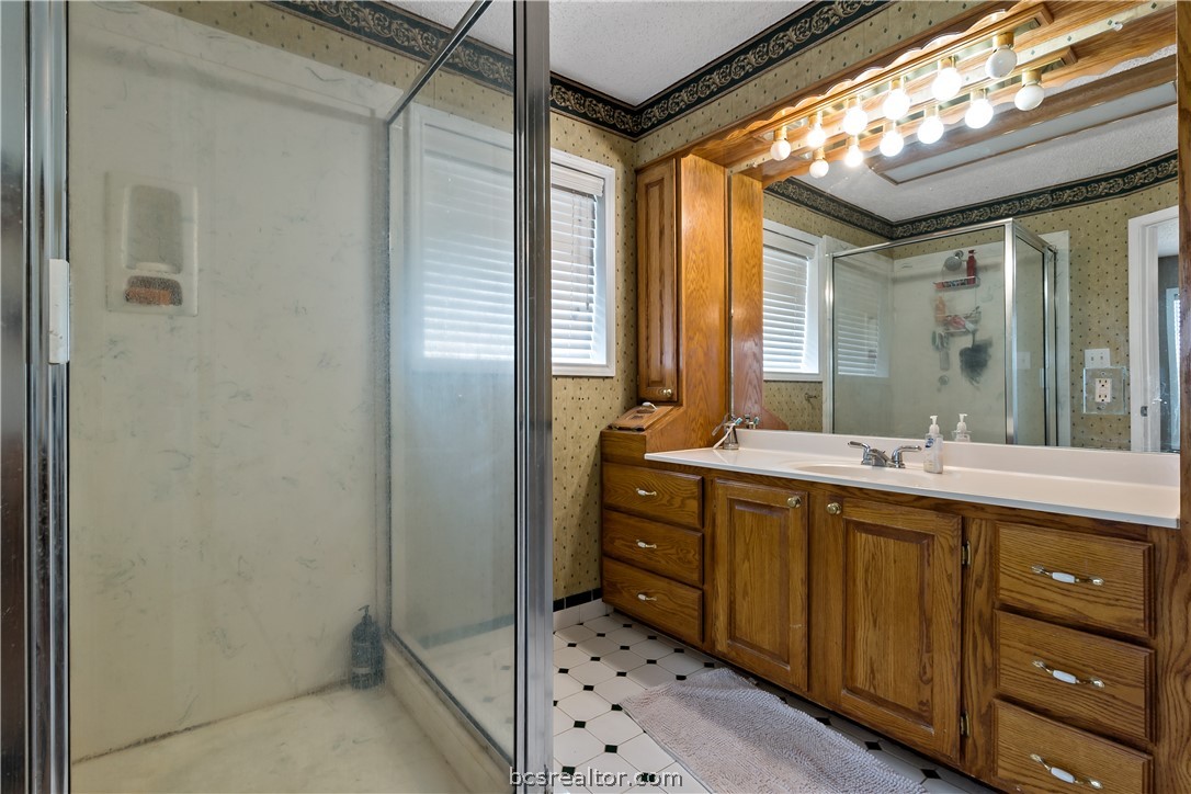 8166 Riley Road Bryan, TX 77808 - Photo 34 of 46 a spacious bathroom with a double vanity sink mirror and shower