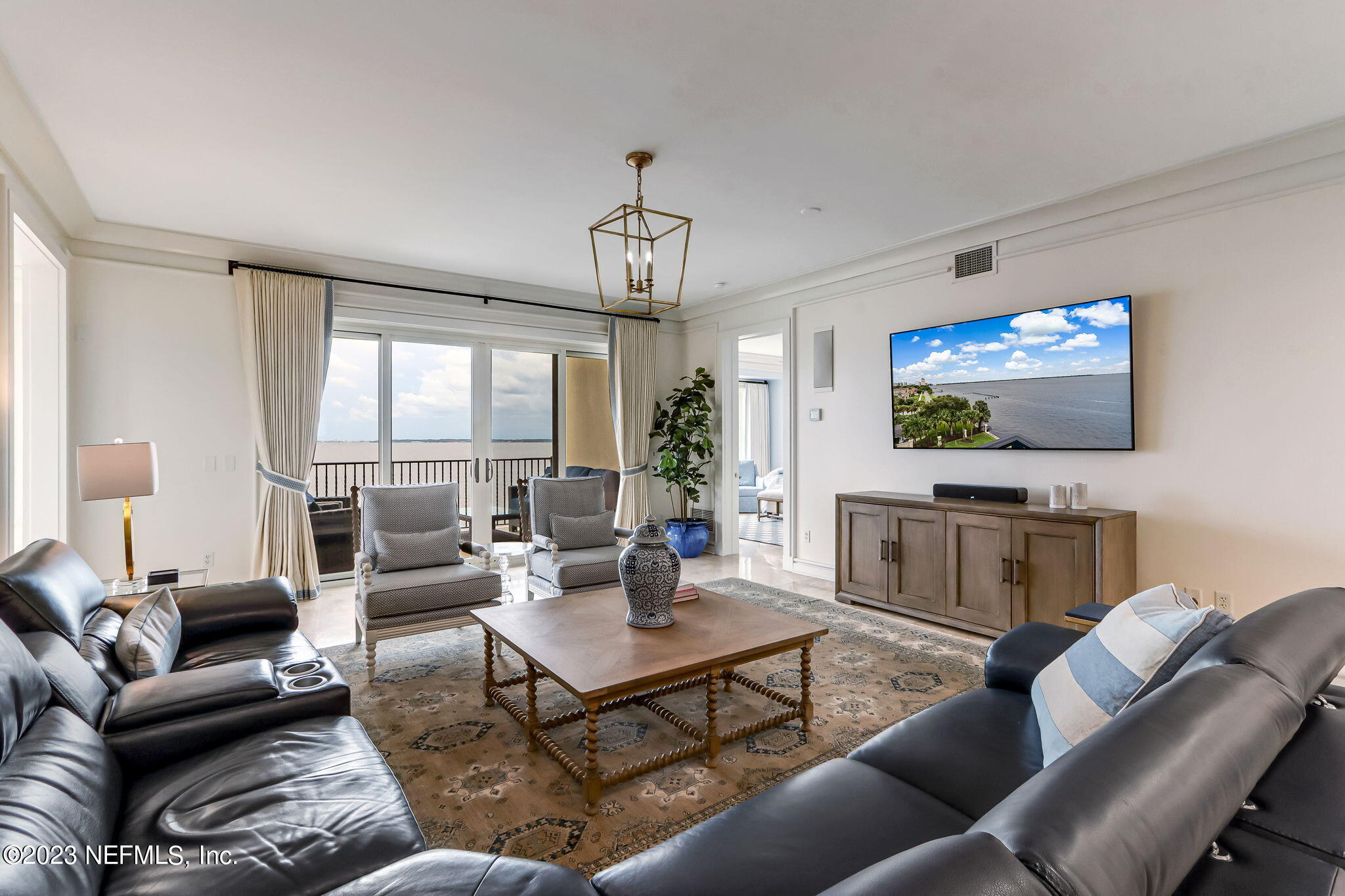 2358 Riverside Avenue, Unit 401 Jacksonville, FL 32204 - Photo 16 of 92 a living room with furniture a dining table and a flat screen tv