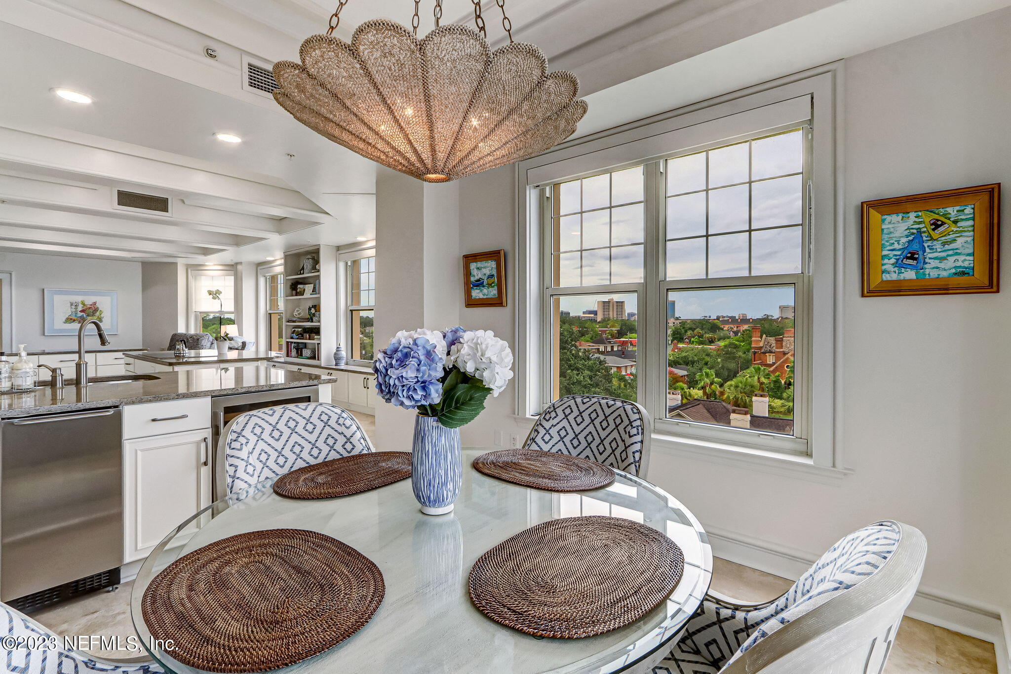 2358 Riverside Avenue, Unit 401 Jacksonville, FL 32204 - Photo 20 of 92 a view of a dining room with furniture a chandelier and large windows