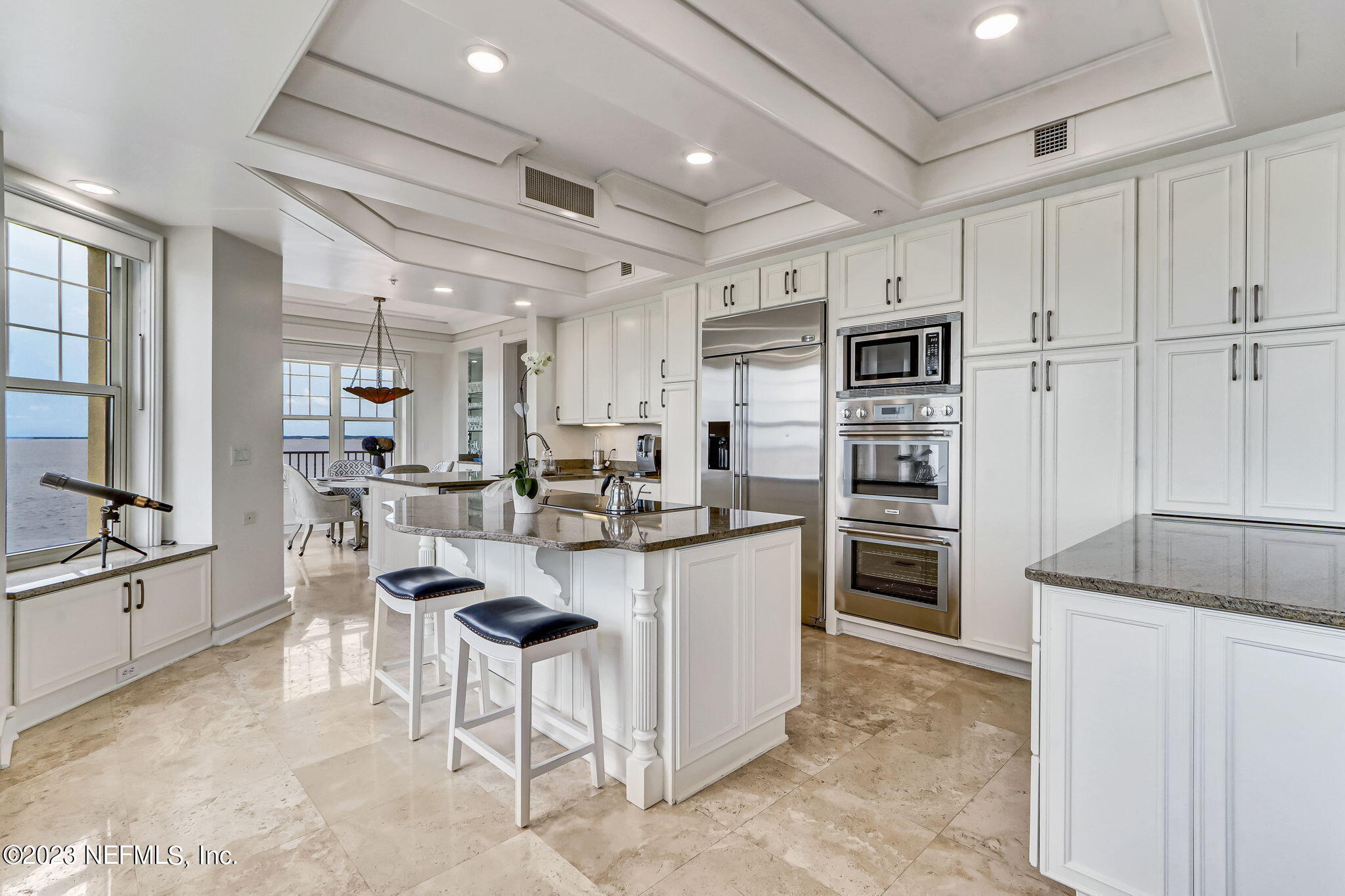 2358 Riverside Avenue, Unit 401 Jacksonville, FL 32204 - Photo 25 of 92 a kitchen with stainless steel appliances kitchen island granite countertop a refrigerator and a stove top oven