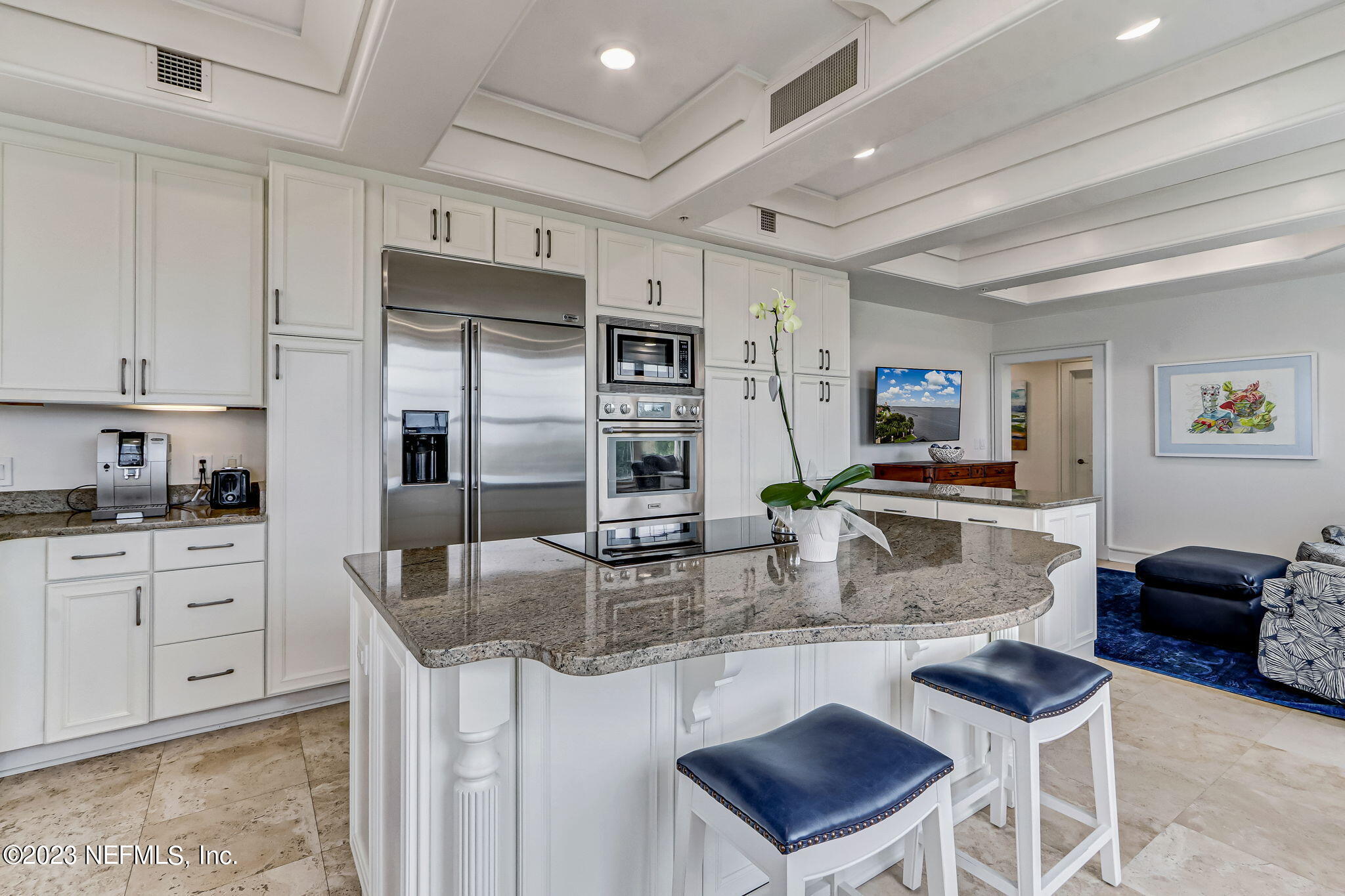2358 Riverside Avenue, Unit 401 Jacksonville, FL 32204 - Photo 29 of 92 a kitchen with stainless steel appliances granite countertop a stove a refrigerator a sink a dining table and chairs