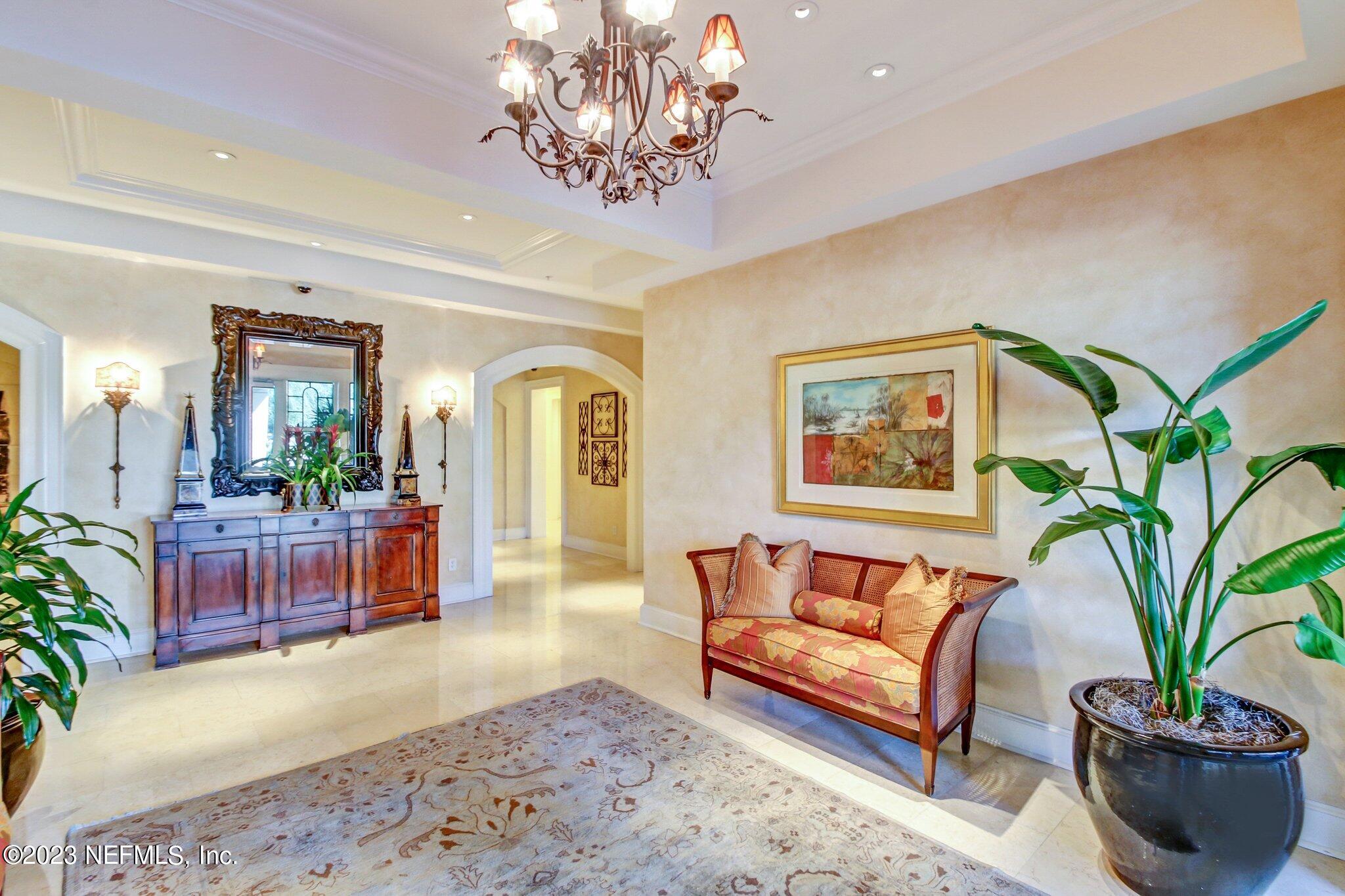 2358 Riverside Avenue, Unit 401 Jacksonville, FL 32204 - Photo 68 of 92 a living room with furniture and a chandelier