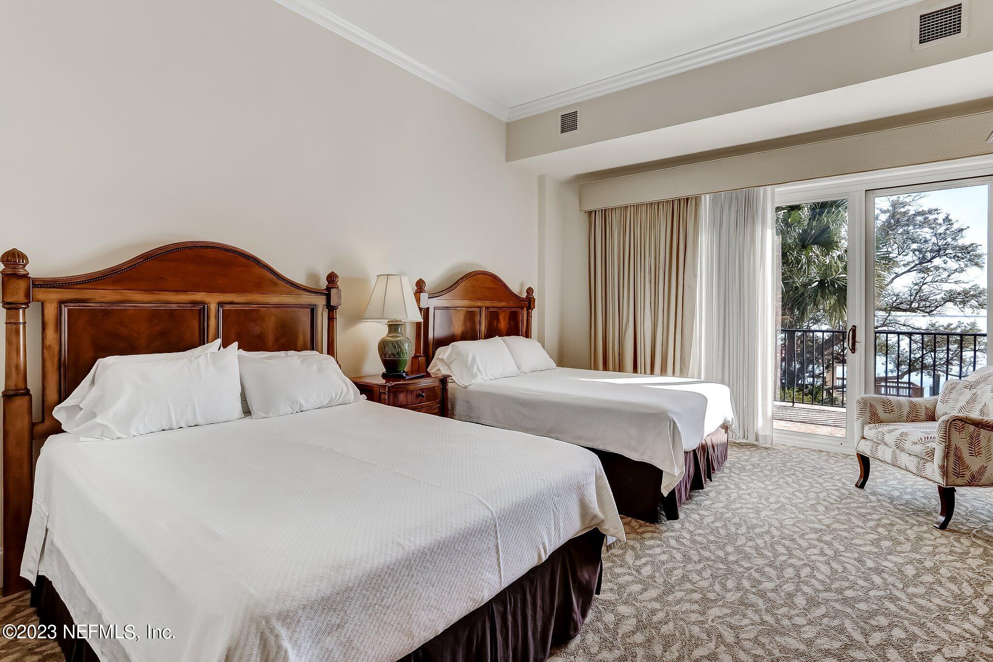 2358 Riverside Avenue, Unit 401 Jacksonville, FL 32204 - Photo 70 of 92 a bedroom with two beds and large window